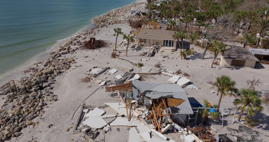 Storm surge severe damage to residential houses on ocean shore after hurricane landfall. Natural disaster consequences in Florida.