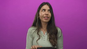 Young hispanic woman using tablet against bright pink background conveying modern technology and digital lifestyle in an isolated and focused setting. - Powered by Shutterstock - Get 15% off with code: PIKWIZARD15