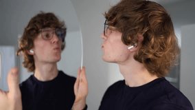 Playful young man puckers his lips toward the mirror pretending to kiss his reflection in a light-hearted and humorous moment of self-love and fun - Powered by Shutterstock - Get 15% off with code: PIKWIZARD15