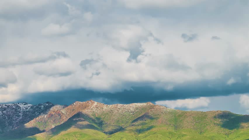 mountain landscape under cloudy sky, dramatic mountain view with thick clouds, scenic cloudy sky over high mountain peaks, peaceful mountain range with misty sky, tranquil alpine scene with cloud cove