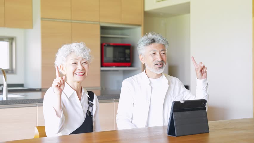 Senior couple looking at a tablet together