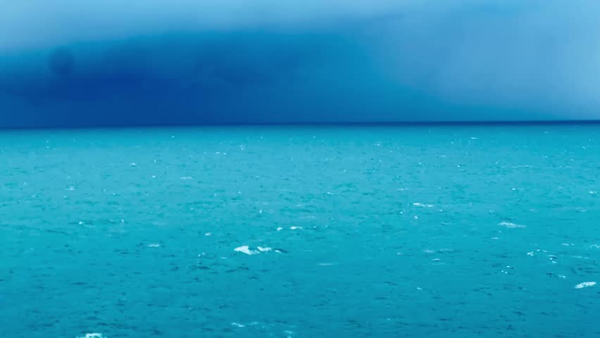 The stormy waves are in the middle of the sea.