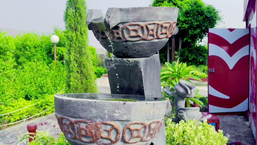 Slowly dipping water into stylish vintage bucket in green park, Vintage style bucket filled with water in peaceful green park, Serene green park scene with slow water dip in bucket

