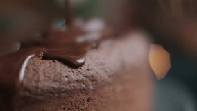 A captivating slow-motion extreme close-up showcases luscious, melted chocolate sauce pouring and flowing over the textured surface of a rich chocolate cake or brownie. This is bakery advertising. - Powered by Shutterstock - Get 15% off with code: PIKWIZARD15