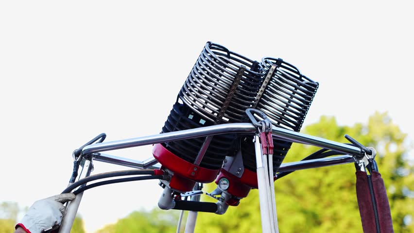 Close-up of the gas burner assembly on the basket of a travel balloon.