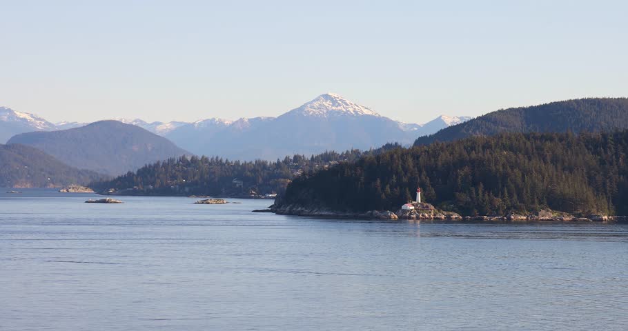 Stunning Coastal Scenery with Lighthouse and Majestic Snow-Capped Mountains in Vancouver, British Columbia