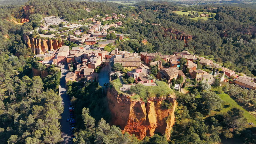Drone view of Roussillon village built on red ochre cliffs in the Luberon region of Provence
