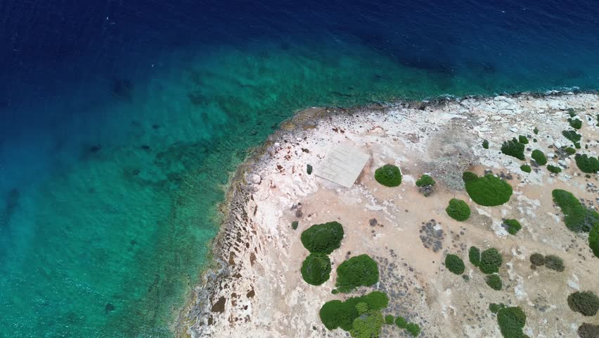 Island Moni Aeginas, Greece - June 22nd, 2025 - footage of uninhabited island next to island Aegina in Saronic gulf, summer landscapes, coastline, yachts, beach bar and wild deer and peacocks