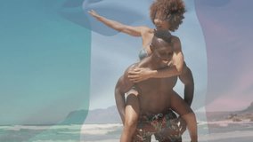 Couple piggybacking at waterline starting technology flag graphic fading behind showing unity. Romance, affection, leisure, outdoor, vibrant, unity, carefree - Powered by Shutterstock - Get 15% off with code: PIKWIZARD15