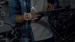 Technician tapping and swiping tablet in bike shop while diagnostics graphics pulsing around head. Technology, innovation, data, connectivity, engineering, maintenance, digital - Powered by Shutterstock - Get 15% off with code: PIKWIZARD15