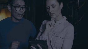 Woman tapping tablet and starting encryption overlay securing data while man monitoring progress. Cybersecurity, data protection, digital infrastructure, technology, industrial, collaboration, - Powered by Shutterstock - Get 15% off with code: PIKWIZARD15