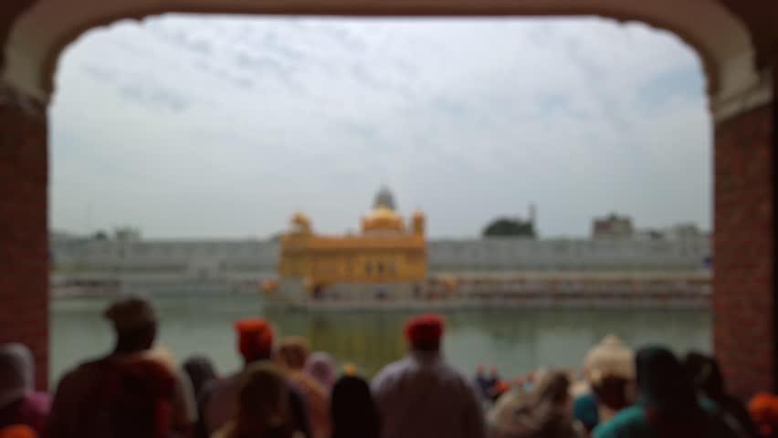Bokeh view of devotees visiting Golden temple in Amritsar, India. Blurred background footage.