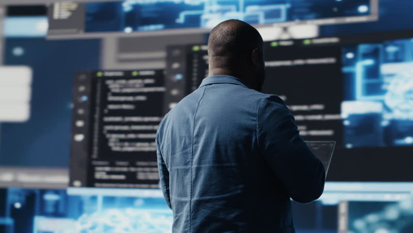 Black IT engineer working in a digital environment with programming language and data science algorithm. Specialist reviews code development, automation and innovation. Coding life. Camera B.
