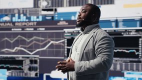 African american public speaker business coach hosting dynamic presentation with a live audience, building new fruitful strategy at a convention. Ideas and forecasting in business event. Camera B. - Powered by Shutterstock - Get 15% off with code: PIKWIZARD15