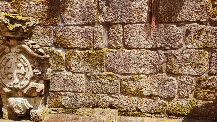 Within Guimaraes, Portugal The Ruins of the Paco dos Condes de Barcelos Palace stand as a picturesque shell of arches balconies and granite chimneys
