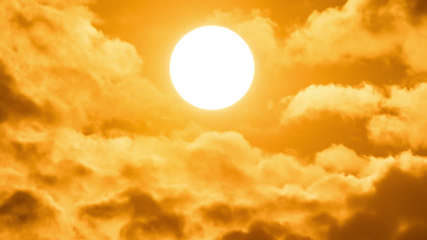 Timelapse of dramatic sunset with orange sky in a cloudy day.