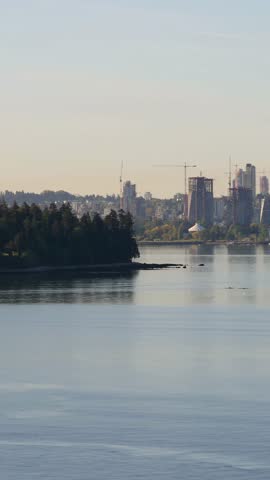 Scenic Morning View of Vancouver City Skyline Approaching by Ship Across Calm Pacific Waters.
