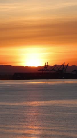 Golden Sunset View From a Cruise Ship Approaching the Industrial Port of Vancouver, British Columbia