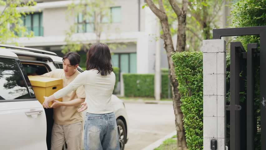 Holding packages, they transition joyfully, fostering a lively indoors and promising future.
