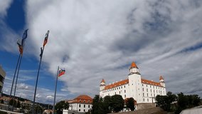 Panoramic footage shows the castle of Bratislava with Slovakian and European Union flags waving. Blue sky with clouds at the background. - Powered by Shutterstock - Get 15% off with code: PIKWIZARD15