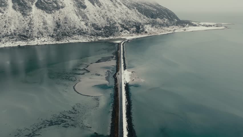Causeway Road Across The Fjord During Winter In Lofoten Island, Norway. - aerial shot