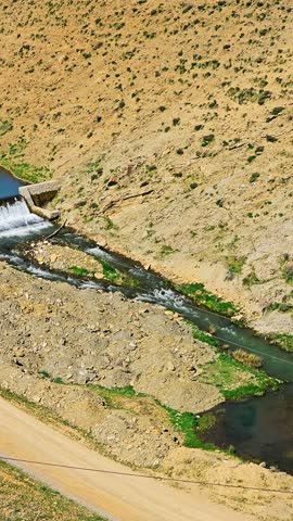A modest dam lies between sunlit hills, reflecting the blue sky in quiet harmony with the surrounding dry terrain.
📍Marivan - Kurdistan 