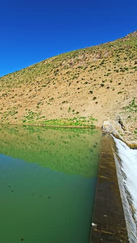 A tranquil dam rests among green hills, releasing clear water into a winding stream—where nature and craftsmanship coexist in peaceful harmony.
📍Marivan - Kurdistan 