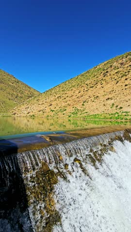 A tranquil dam rests among green hills, releasing clear water into a winding stream—where nature and craftsmanship coexist in peaceful harmony.
📍Marivan - Kurdistan 