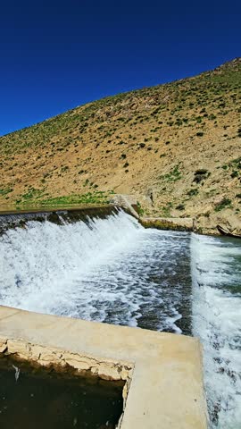 A tranquil dam rests among green hills, releasing clear water into a winding stream—where nature and craftsmanship coexist in peaceful harmony.
📍Marivan - Kurdistan 