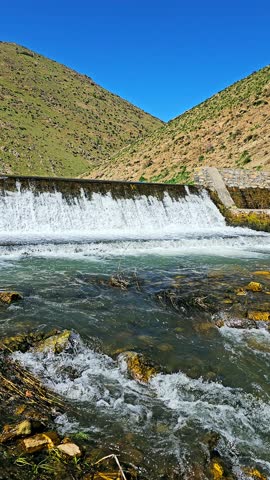 A tranquil dam rests among green hills, releasing clear water into a winding stream—where nature and craftsmanship coexist in peaceful harmony.
📍Marivan - Kurdistan 