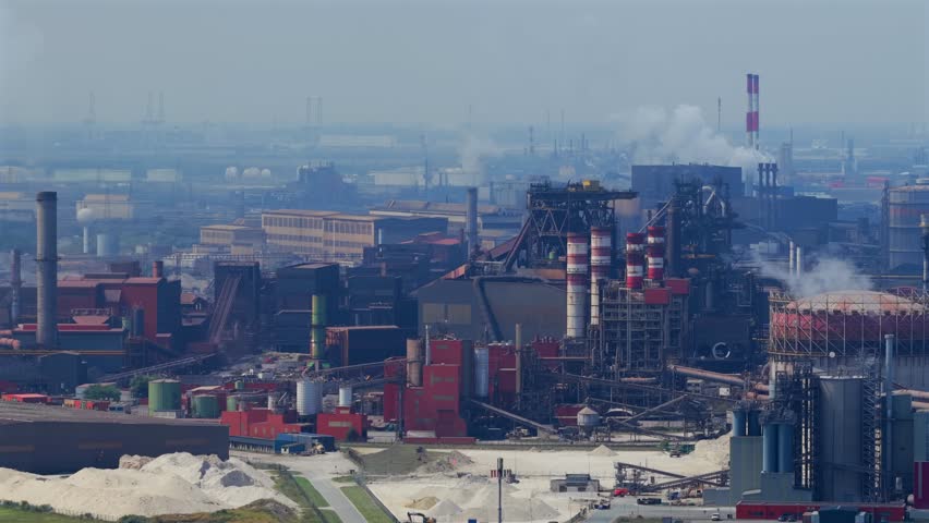 Factories contributing to climate change and global warming - Large Industrial zone burning fossil fuels and polluting the atmosphere 