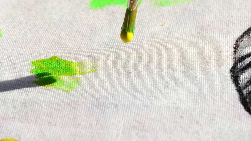 Artistic brushstroke painting neon green swirl on canvas in high definition slow motion detail.