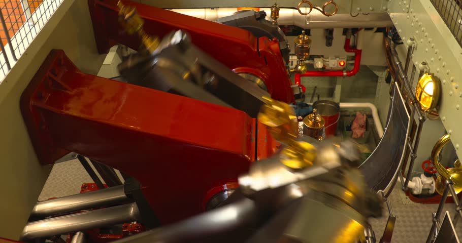 Active Steam Engine Aboard Ship with Red Machinery