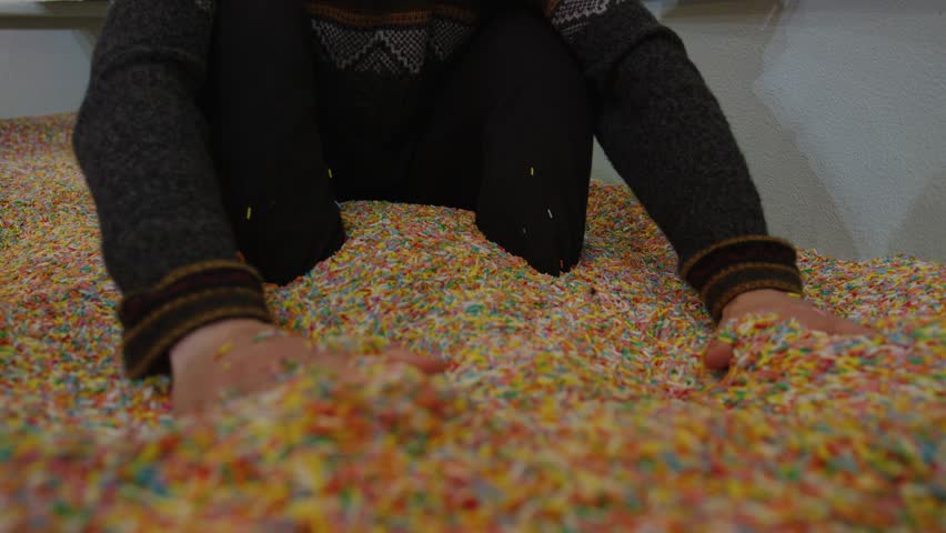 Slowmotion close up of hands digging through vibrant sprinkle pit candy texture resembling pastry toppings colorful sugar details playful dessert inspired atmosphere surreal sweet environment - Powered by Shutterstock - Get 15% off with code: PIKWIZARD15