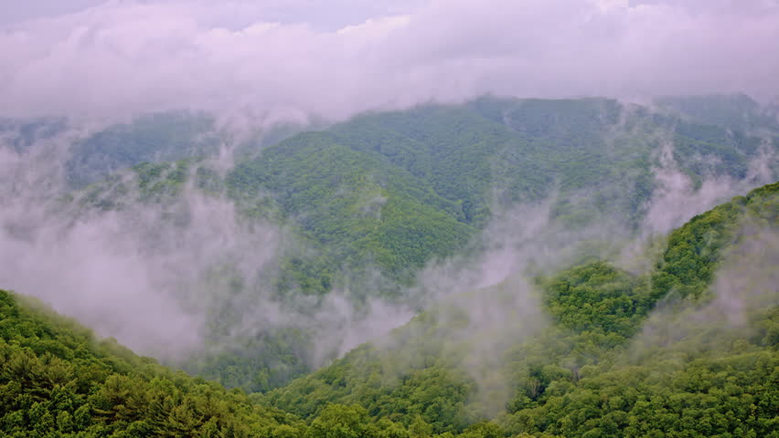 Cinematic drone shot of the great smoky mountains full of mist and fog
