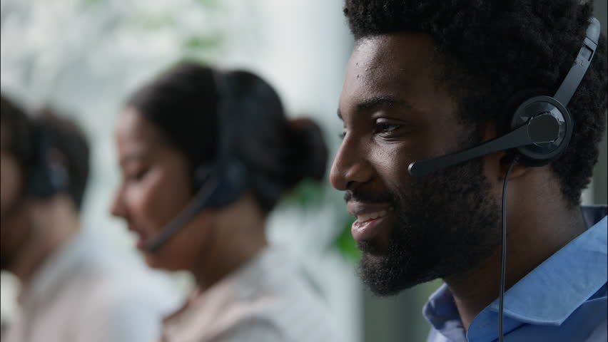 Callcenter headshot African operator in headset support customer helpline online sales business trading talking multiethnic Hispanic workers close up consulting client call center help agency office