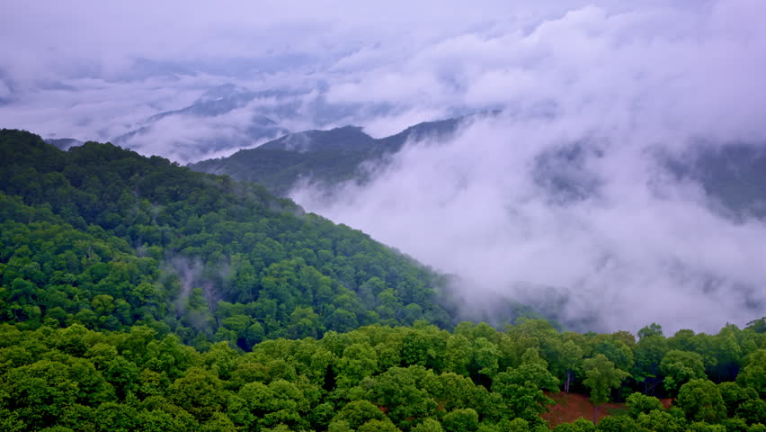 The Great Smoky Mountains enveloped in haze, filmed from above.