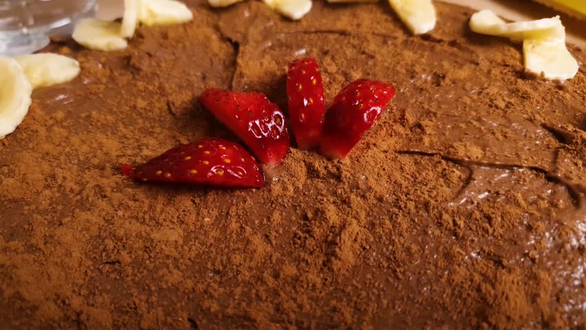 Strawberries on chocolate cake dessert decoration. Strawberry-chocolate cake,cream cake with cream and cocoa.