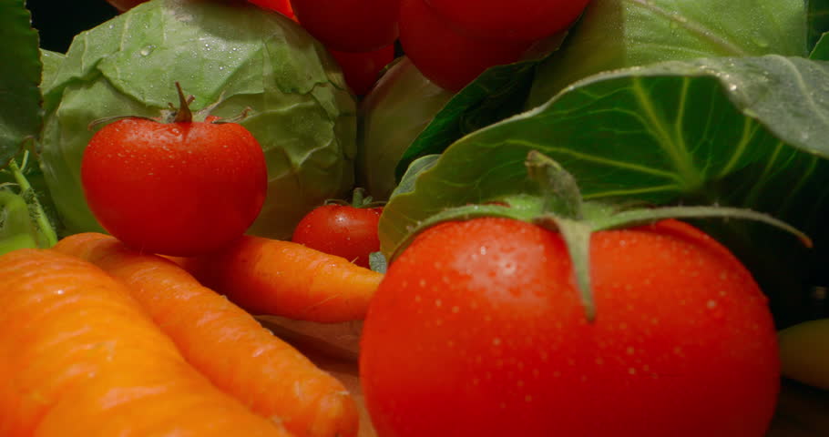 Fresh organic vegetables tomatoes carrots cabbage cauliflower bell pepper garlic cloves leafy greens, promoting healthy eating farm produce diet nutrition vitamins