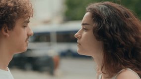 Close-up of a young couple having a heated argument on a city street. Their faces are tense, emotions are high, and they are locked in intense eye contact, yelling loudly. - Powered by Shutterstock - Get 15% off with code: PIKWIZARD15