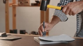 Closeup Workshop background tailor use tool for making holes in leather to create straight seam. - Powered by Shutterstock - Get 15% off with code: PIKWIZARD15