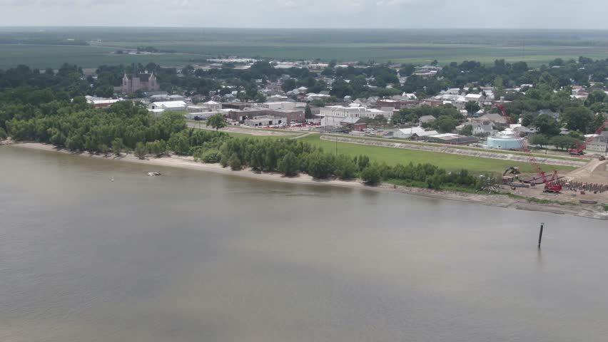 An aerial view of the Mississippi River, levee park trails, neighborhoods, and city of Donaldsonville, Louisiana.