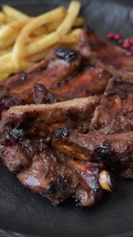 Meat, beef ribs in a marinade grilled with salt and spices. Grilled ribs, barbecued meat food