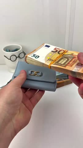 Small Blue Purse Handling Big Money