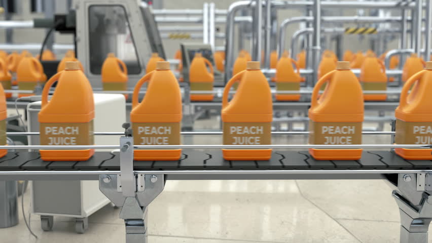 Manufacturing peach juice drink at the modern production factory. Juice beverage moving on the factory production line. Factory mass production process of the juice drinks in bottles.