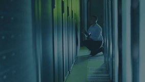 IT technician kneeling at data center rack tapping tablet spawning network logs during diagnostics. Technology, cybersecurity, infrastructure, innovation, enterprise, data, connectivity - Powered by Shutterstock - Get 15% off with code: PIKWIZARD15