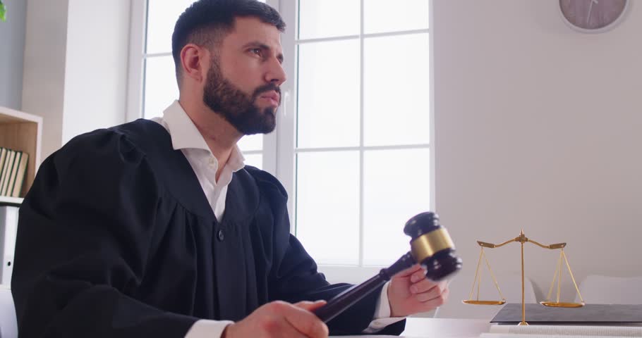 Judge delivers verdict and strikes gavel or mallet in courtroom during lawsuit session, focusing on punishment and judgment with authority, in a professional setting with a sense of legal enforcement.