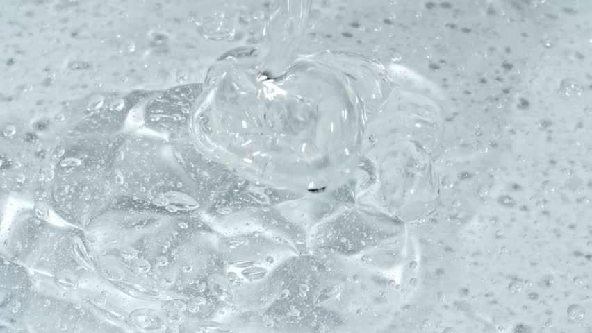 Closeup Shot of Clear Cosmetic Gel Fluid, Essential Oil With Molecule Bubbles Flowing on White Background. Macro Shot of Organic Products, Medicine. Dermatology Science Laboratory. 