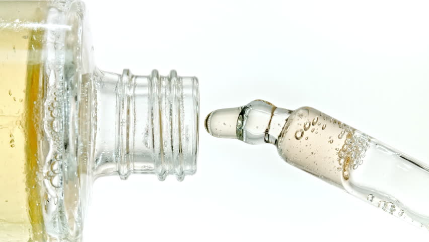 Pipette with Serum, Gel, Oil or Other Cosmetic Product Dripping Slow Motion. Macro Shot of Natural Organic Cosmetics, Medicine. Production Close-up. Skin or Body Care Products