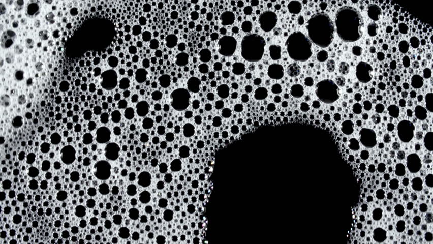 Texture of white soap foam with bubbles abstract background. Soap sud macro structure. Bathtup Soap Foam. Natural White Shampoo Bubbles Motion.